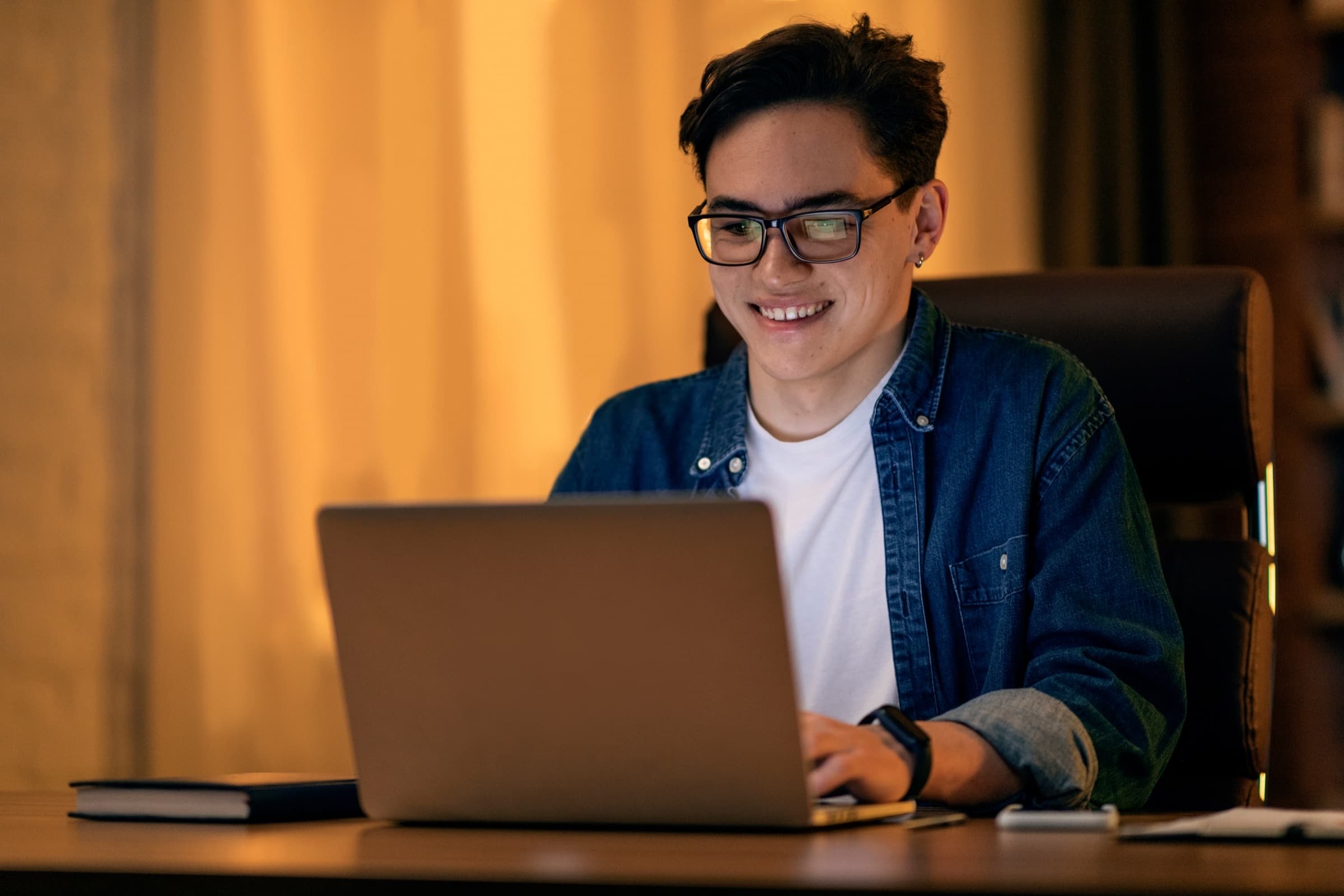 Smiling freelancer working on a laptop at home