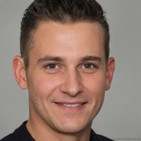 Smiling man with short dark hair